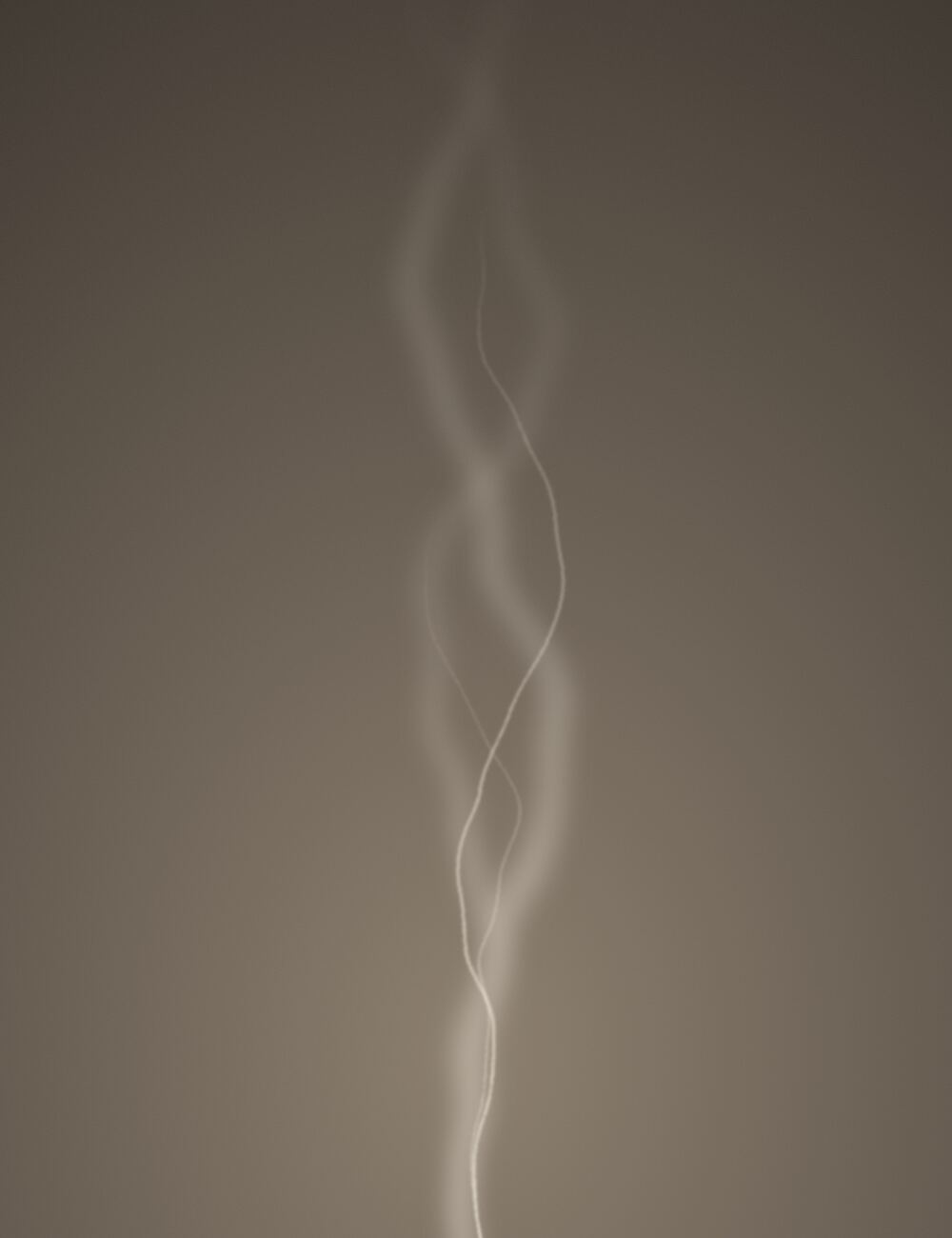 A thin line of smoke rising